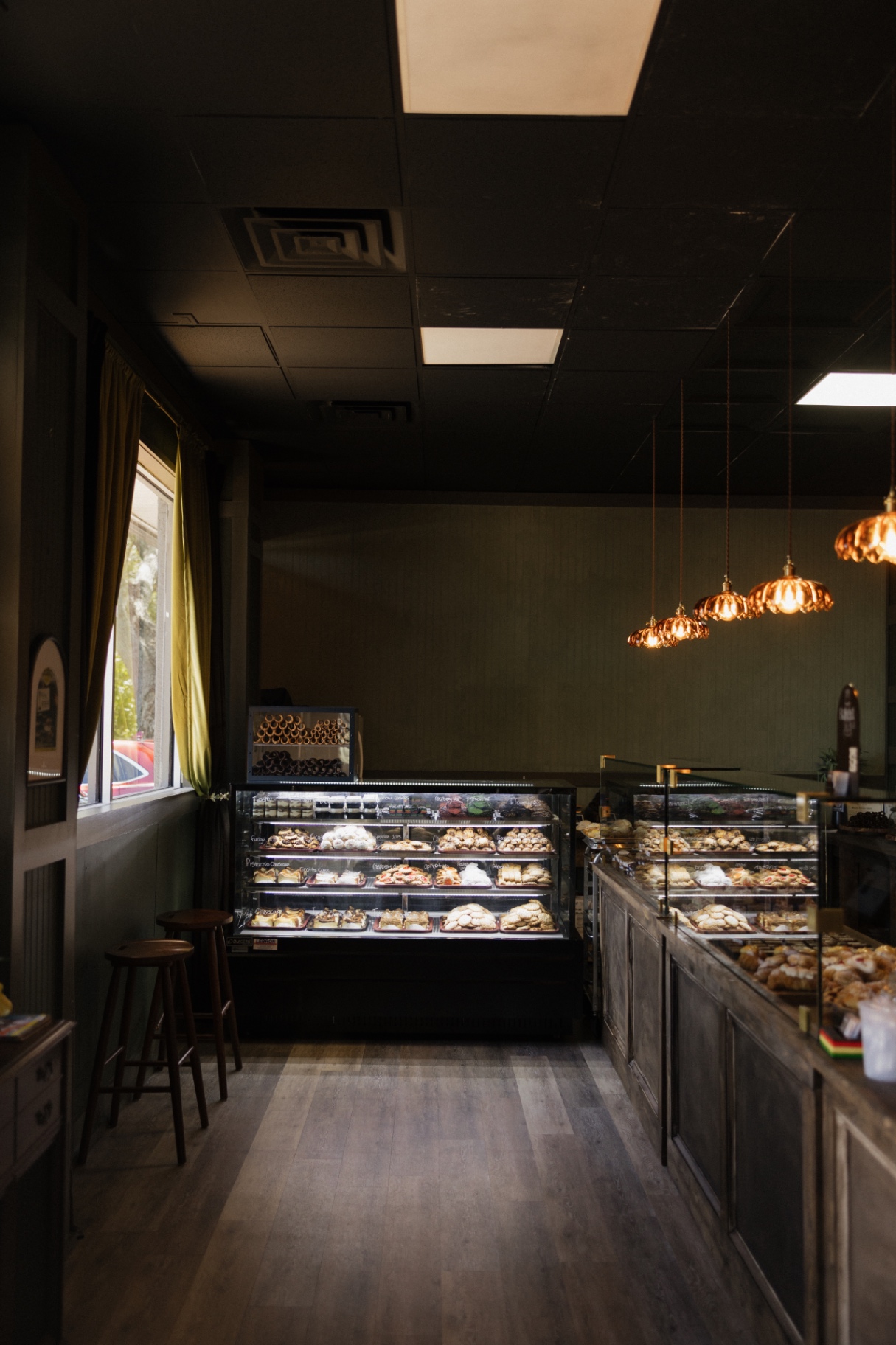 The bakery's olive-green walls, black ceiling and copper pendant lights